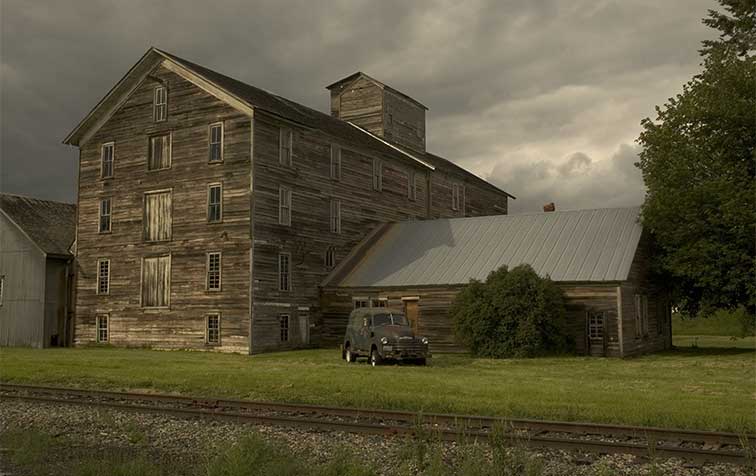 Photo of the historic Barron Flour Mill under stormy clouds.